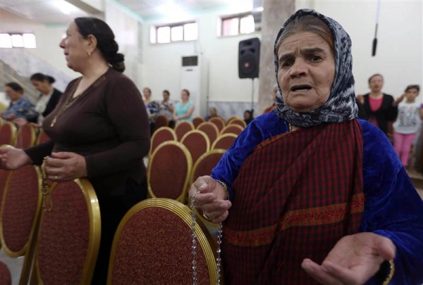 Iraqi Christians who fled the violence in the northern city of Mosul pray at a church in the village of Qaraqosh on July 19. Photo: NBC News
