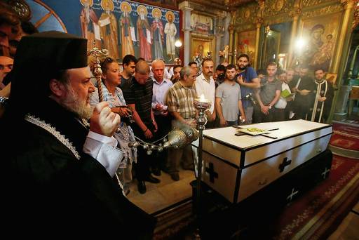 People pray over casket of Palestinian Christian woman who doctors said was killed in an Israeli air strike. Reuters/Suhaib Salem