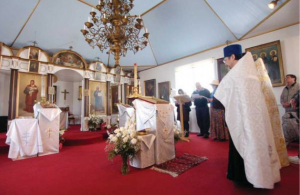 File Photo/Peninsula Clarion Father Thomas Andrew and others bless items inside of the Holy Assumption of the Virgin Mary Russian Orthodox Church in April 2010 before they were transferred to the Kenai Cultural and Visitors Center for a summer art gallery show while the church was being renovated. That project was phase one of the church's three-phase project to completely renovate the church. The church is set to receive $230,000 from the Alaska State Legislature's capital budget that would go toward fire and theft prevention systems, among other items, as part of phase two of the renovations.