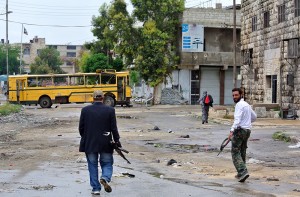 Rebel fighters walk towards the front line in the Sheikh Maqsud neighborhood in the northern Syrian city of Aleppo, on May 13, 2013. The European Commission announced an additional 65 million euros ($84 million) in aid for Syrian refugees and internally displaced, warning the crisis is "already at breaking point". AFP PHOTO/STR        (Photo credit should read -/AFP/Getty Images)