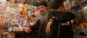 Michael Wilson sits in his "cell" at his rural Lawrence home on a recent day. Wilson spends time in the reconfigured shed, studying and contemplating his faith. The 55-year-old Lawrence man has transformed in recent years from a Rastafarian to a Serbian Orthodox deacon.