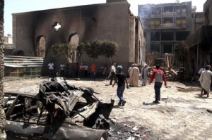 Egyptian gather in the ruins of the Evangelical Church of Malawi after it was ransacked, looted and burned on Thursday by an angry mob, in Malawi, south of Minya, Egypt, Saturday. In the province of Minya south of Cairo, protesters attacked two Christian churches, security officials said. Roger Anis/El Shorouk Newspaper/AP