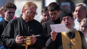 Vitaly Milonov (L) attending church service