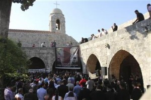 A general view shows people attending a candle-lit vigil at the Balamand Monastery in Koura, near Tripoli, to call for the release of bishops kidnapped in northern Syria two months ago, June 22, 2013. REUTERS/Omar Ibrahim