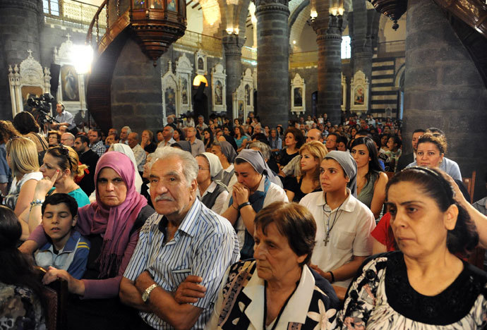 Syrian Christians attend a prayer vigil for peace at the Lady of Dormition, the Melkite Greek Catholic patriarchal cathedral in the Old City of Damascus, on September 7, 2013.(AFP Photo / STR)