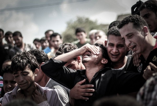 Palestinian relatives mourn during the funeral of eight members of the same family who were killed overnight in an Israeli strike on July 19, 2014 in Beit Lahia, north of the Gaza strip. (Hosam Salem—NurPhoto/Corbis)