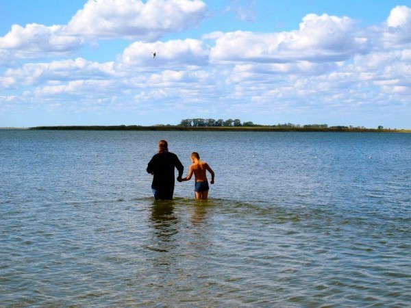 Vladika Philip baptizes children in the lake near the village of Blagodatnoye, August 18, 2012.