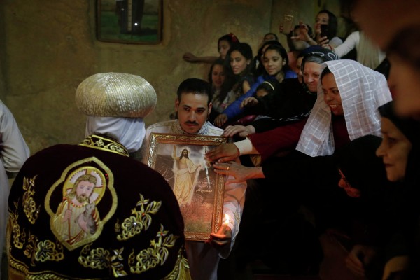 Egyptian Coptic Christian pray during the Easter Eve service at St. Sama'ans Church in the Mokattam district of Cairo, Egypt. April 11, 2015.