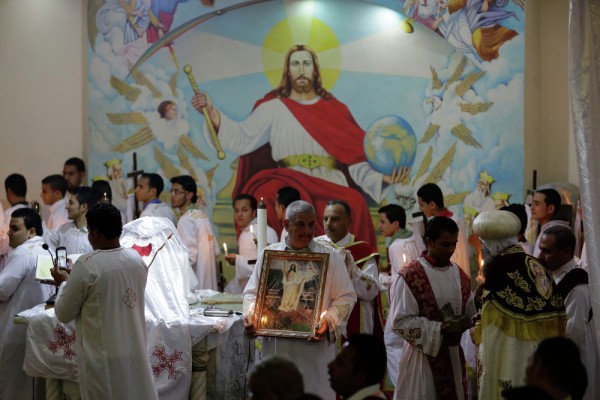 Egyptian Coptic Christians pray during the Easter Eve service at St. Sama'ans Church in the Mokattam district of Cairo, Egypt. April 11, 2015.