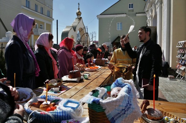 An Orthodox priest blesses traditional Easter cakes and painted eggs in preparation for an Easter celebration at a church in the town of Novogrudok, 150 kilometers (93 miles) west of the capital Minsk, Belarus. Saturday, April 11, 2015.