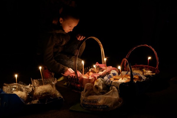 A Kyrgyz Orthodox worshiper lights candles as she celebrates Orthodox Easter during a midnight mass at a church in Bishkek. April 12, 2014.