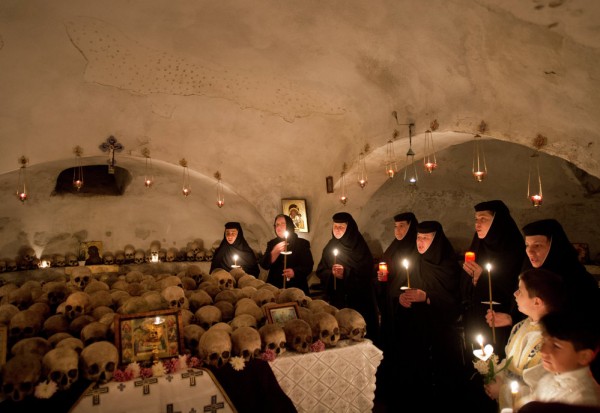 Romanian nuns and believers attend a religious service during Easter celebrations at the Pasarea Monastery in Pasarea. April 11, 2015.