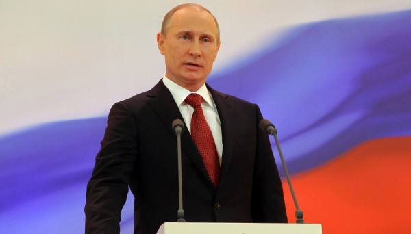 Vladimir Putin speaks with his hand on the Constitution during his inauguration ceremony as new Russia's president in Moscow Monday, May 7, 2012.  Putin has been sworn in as Russia's president for a third term after four years as prime minister. (AP Photo/RIA Novosti Kremlin, Vladimir Rodionov, Presidential Press Service)