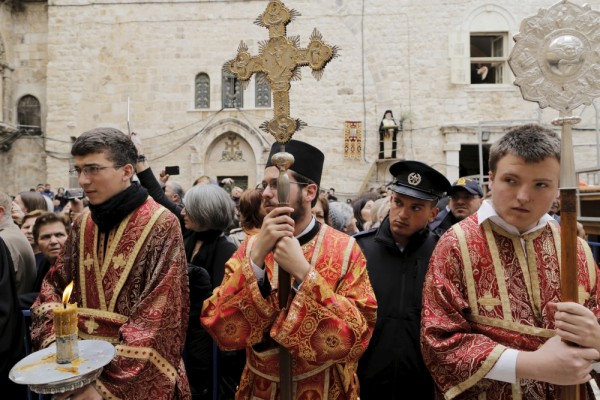 PHOTO: REUTERS/AMMAR AWAD. Members of the Greek Orthodox clergy await the arrival of the Greek Orthodox Patriarch of Jerusalem Metropolitan Theophilos before the washing of the feet ceremony outside the Church of the Holy Sepulchre in Jerusalem's Old City, April 9, 2015, ahead of Orthodox Easter.