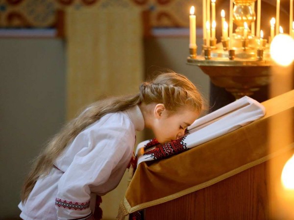 A young girl kisses the Virgin Mary at the front of the church. Christ the Saviour Orthodox Church held their Christmas service. JULIE OLIVER / OTTAWA CITIZEN