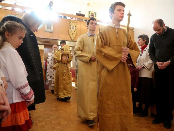 Altar boys Nicholas La Libertie (front) and Thomas Howarth lead Deacon Michael La Libertie and Father Maxym Lysack (rear) on a procession through the congregation during the service. JULIE OLIVER / OTTAWA CITIZEN