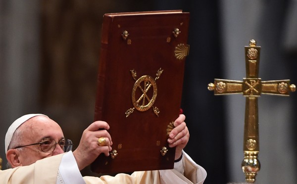 Pope Francis holds the book of the Gospels during the Epiphany mass Gabriel Bouys/AFP