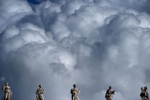 Heavy clouds are seen above statues in the Vatican before the Angelus prayer on Epiphany's day Gabriel Bouys/AFP