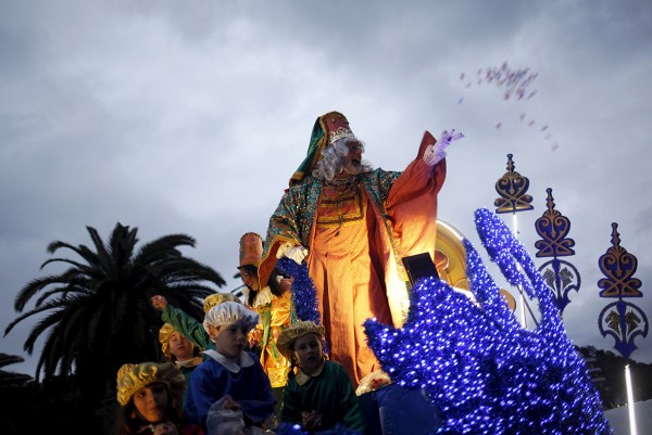 An actor dressed as Melchior, one of the Three Wise Men, throws sweets to children in Malaga, southern Spain Jon Nazca/Reuters