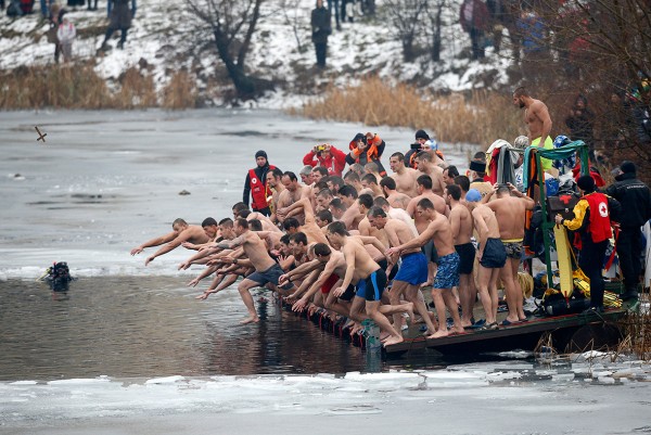 Men jump into the waters of a partly frozen lake in an attempt to grab a wooden cross on Epiphany Day in Sofia, BulgariaStoyan Nenov/Reuters