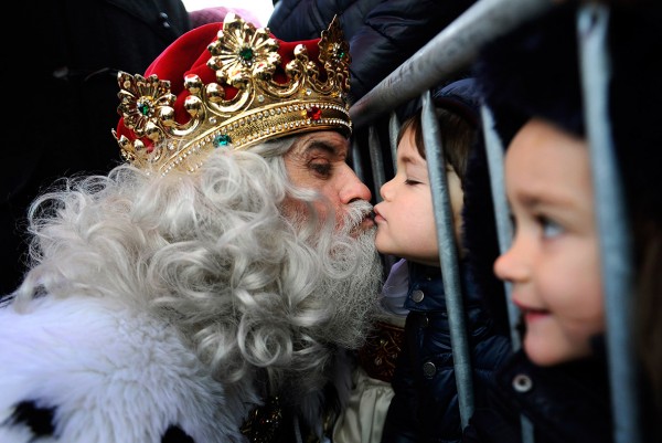 A man dressed as one of the Three Wise Men kisses a child in Gijon. Children in Spain traditionally receive their Christmas presents delivered by the Three Wise Men on the morning of 6 January, during the Epiphany loy Alonso/Reuters