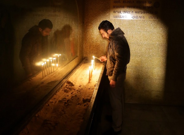 A man lights a candle during Armenian Orthodox Christmas celebrations at the Saint Sarkis Church in Damascus, Syria Louai Beshara/AFP