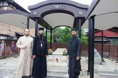 Deacon Iliya Toru with Archimandrite Sergius and Hierodeacon Maximus at the grave of St. Nicholas of Japan in Tokyo’s Yanaka Cemetery.