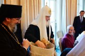 Parishioners of the Russian cathedral in London present a puppy to Patriarch Kirill