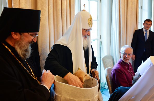 Parishioners of the Russian cathedral in London present a puppy to Patriarch Kirill